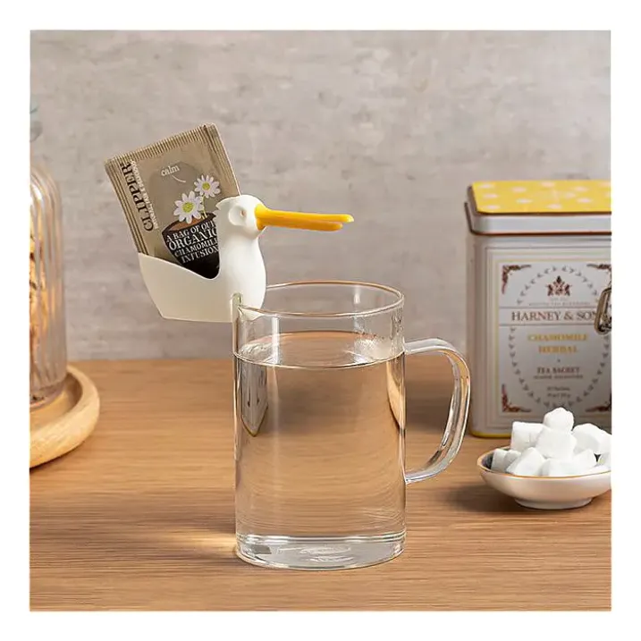 Soporte y colgador de bolsitas de té en forma de pelícano